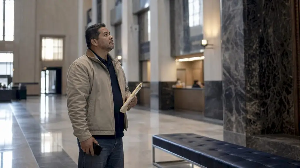 Man standing outside courthouse preparing to surrender